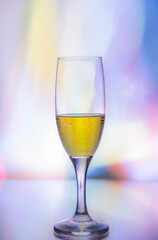 glass glass with champagne on a multicolored background