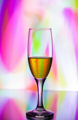 glass glass with champagne on a multicolored background