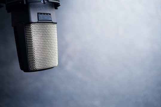 Microphone in a recording studio on a gray background, close up, soft focus 