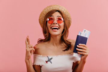 Close-up portrait of cheerful happy girl, crossed her fingers and looking enthusiastically upwards....