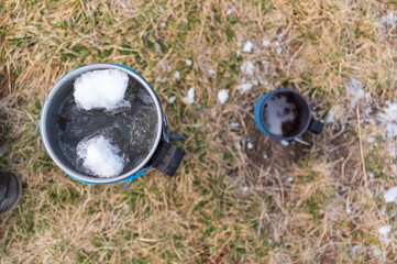 Gas melting snow. Distilled water for coffee or tea.