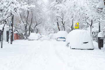 Cars covered with snow in the historical Snowtorm over Madrid city, Spain.