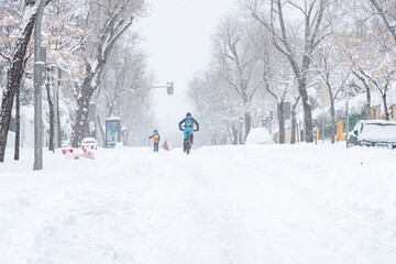 People enjoying the historical Snowtorm over Madrid city, Spain.