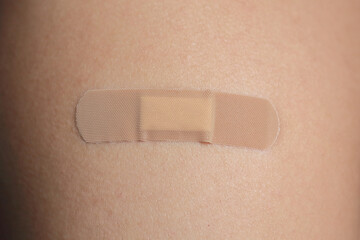 adhesive bandage on the young Caucasian male skin