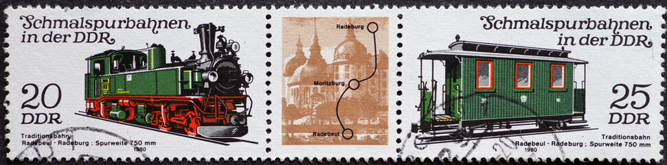 GERMANY, DDR - CIRCA 1980 : a postage stamp from Germany, GDR showing the locomotive and an antique passenger car of the narrow-gauge railway Radebeul Ost – Radeburg (gauge 750 mm) and a passenger car