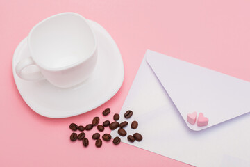 Blank envelope isolated and empty White cup with roasted coffee beans on pink background