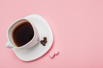 a cup of coffee with hearts made of marshmallow on pink background. Morning mood concept