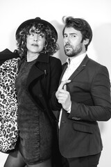 A Caucasian couple in a black and white fashion shoot, looking at each other on Valentine's Day