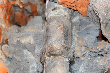 Fototapeta premium an old joint pipe in the whole in the wall