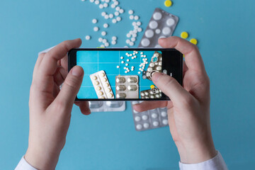 Medicine blogger taking mobile photo of pills and tablets for blog, pharmacy content