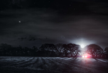 Fototapeta premium Lone driver in a dark field