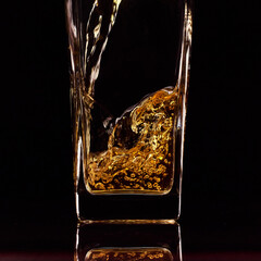 Close up of pouring fresh apple juice into glass