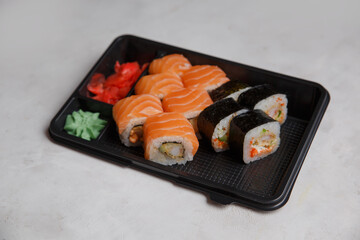 Sushi order, different rolls, pink ginger, wasabi, sushi delivery concept. Ordering Japanese food