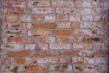 texture of an old brick wall of a house. Red brick with white patina