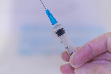 Human Hand with injection Syringe, on white background.