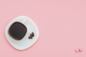a cup of coffee with hearts made of marshmallow on pink background. Morning mood concept