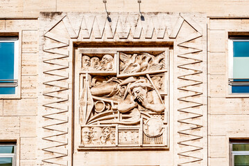 High relief in the façade of a building in piazza Affari, beside the Milan Stock exchange, Milan, Lombardy, northern Italy
