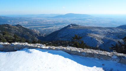 Fototapeta na wymiar Breathtaking scenic view to whole Athens - Attica from snowed peak of Parnitha mountain, Greece