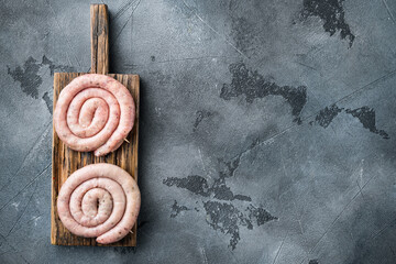 Raw meat sausage, on gray background, top view flat lay , with space for text  copyspace