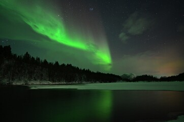 Aurora borealis over the lake in Finnmark, Norway