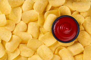 Background of potato chips with sauce, close up. Top view.