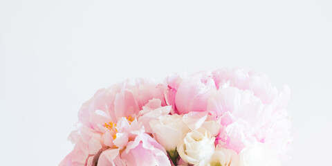 Closeup of pink pastel peony bouquet on gray banner. Floral arrangement