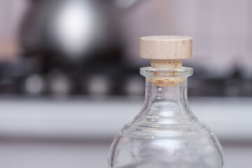 Transparent bottle with wooden cork in the kitchen.