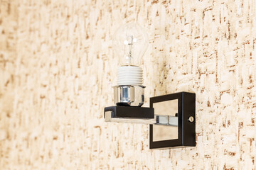 handyman assembling and installing wall light lamp. home lighting equipment