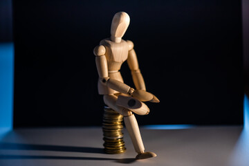 Business concept photo. Wooden man with money. Earnings and salary