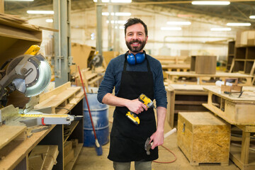Male worker enjoying building a piece of furniture