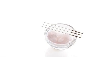 Silver needles for traditional Chinese acupuncture medicine. White background. There is some free space for your text or sign.