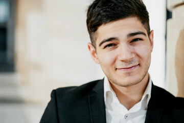 portrait of a professional consultant manager looking at the camera smiling. stylish business suit. hairstyle of the barbershop. copy space