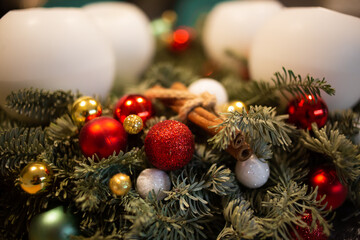 Close up of decorated Christmas pine tree advent wreath with white candles