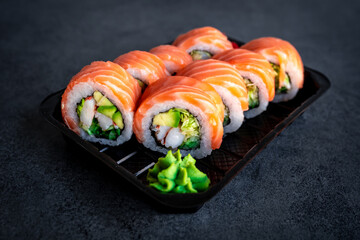 Traditional Japanese rolls with salmon in box