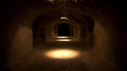 Pass through a long and dark Roman basement. Basement under the amphitheater in El Jem, Tunis. Ancient roman building. The camera is approaching