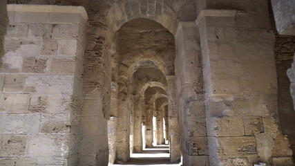 Ancient Roman ruins. Ancient amphitheater located in El Jem, Tunis. The passage between the columns. Historic Landmark.