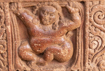 Aihole, Karnataka, India - November 7, 2013: Durga Gudi or Temple. Closeup of brown stone fresco...