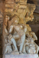 Aihole, Karnataka, India - November 7, 2013: Durga Gudi or Temple. Massive statue of Harihara, dual gender Shiva with 2 minor figures.
