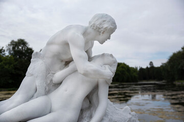 Fototapeta na wymiar Very old sculpture of an embracing couple in white marble