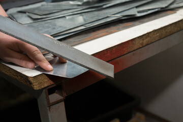 Craftsman Polishes Sharp Metal Edge