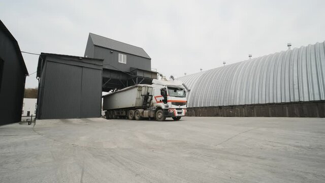 A truck with raw materials leaves the grain storage area. Car weights