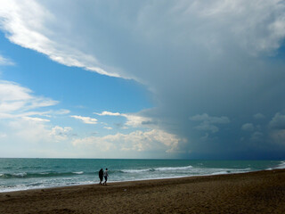 Fototapeta na wymiar Beach Walk With Upcoming Thunderstorm