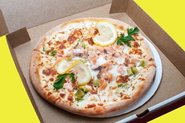 Fish salmon pizza delivery in brown carton box