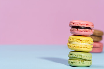 Macaron. Traditional french colorful macarons close up, macro on blue and pink background