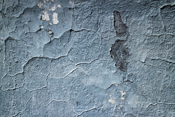 Textured wall with peeling blue paint. Old building. Beautiful abstract background. Large size photo in good quality.