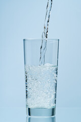 Pouring water. Pouring fresh clean drinking water to glass.