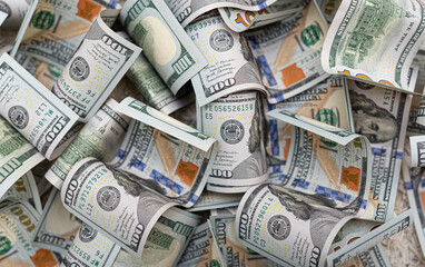 Hundred dollar rolled banknotes as background close-up.