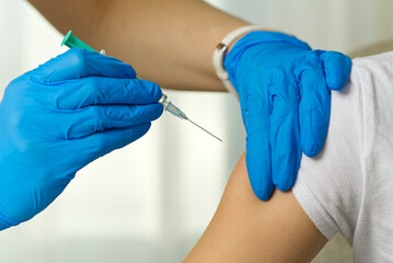 Doctor vaccinates a person against a viral infection in a hospital
