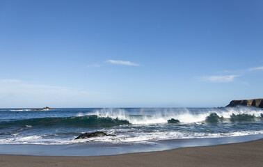 Fototapeta na wymiar Atlantic ocean, strong waves, splashing, breaking on coast, rocks, volcanic island, Azores.