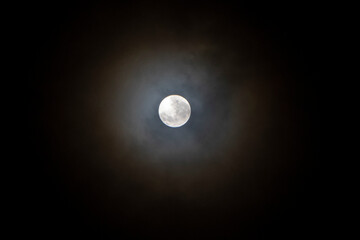 Recife / Pernambuco / Brazil. December, 20.2021. Month full moon seen between clouds.